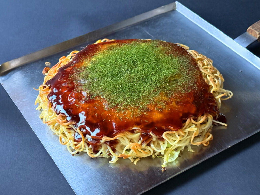 料理から少し離れ、2倍ズーム（2x）を使って撮影したお好み焼き